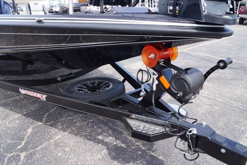 Slide: The Image of 2026 Phoenix 721 ZXL boat trailer with winch and spare tire on asphalt. - 6