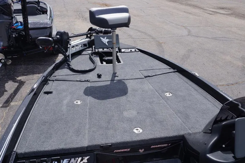 Slide: The Image of 2026 Phoenix 721 ZXL boat deck with seating and equipment, parked on pavement. - 8