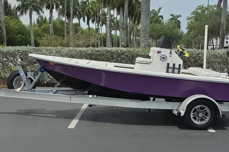 The Image of Purple Aqua Dyne 17 boat on trailer, parked near palm trees, 2016 model. - 0