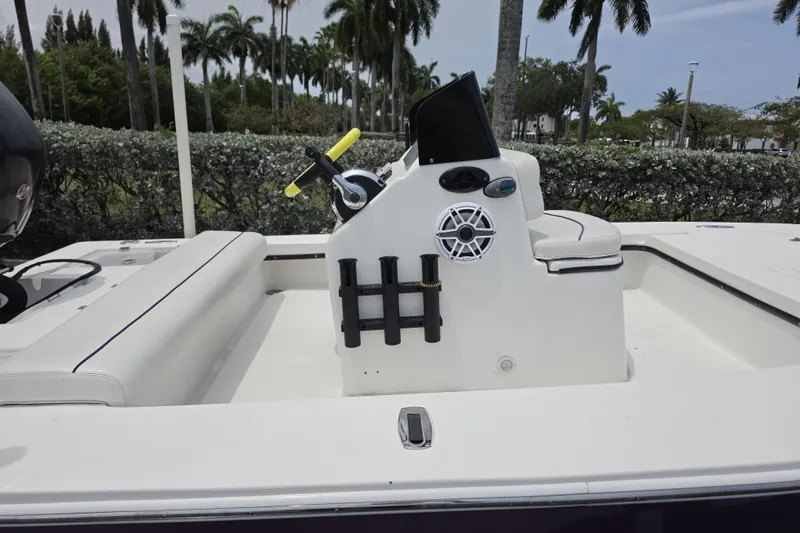 Slide: The Image of 2016 Aqua Dyne 17 boat interior with steering console and seating, surrounded by lush greenery. - 11
