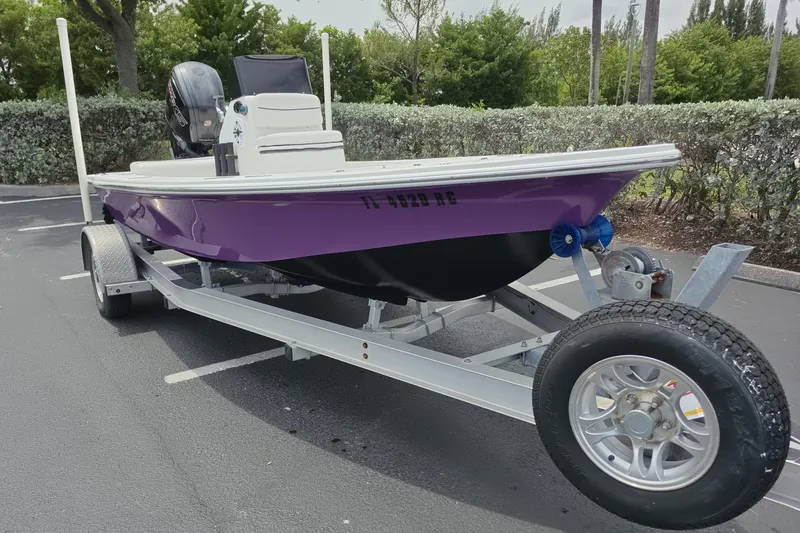 Slide: The Image of Purple Aqua Dyne 17 boat on trailer, 2016 model, parked outdoors. - 3