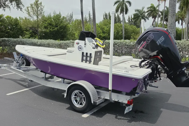 Slide: The Image of 2016 Aqua Dyne 17 boat with Mercury engine on trailer, parked outdoors. - 4