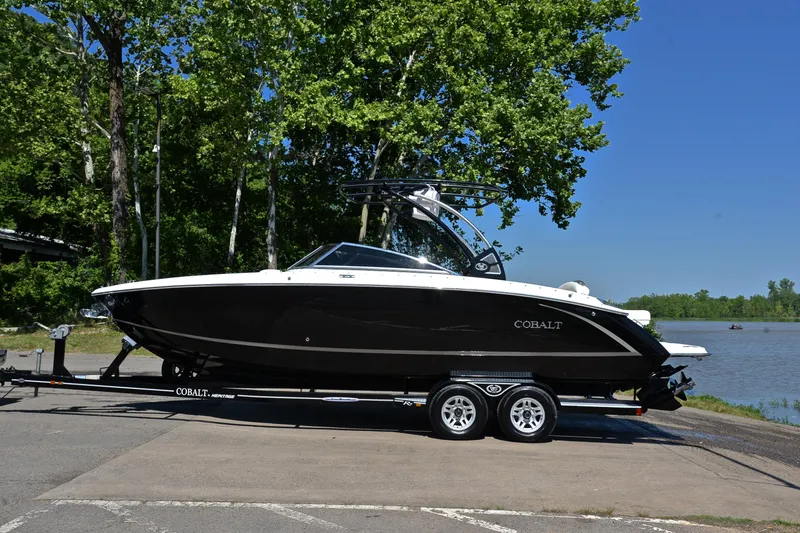 Slide: The Image of 2018 Cobalt R7 boat on trailer by a lake, surrounded by trees. - 12