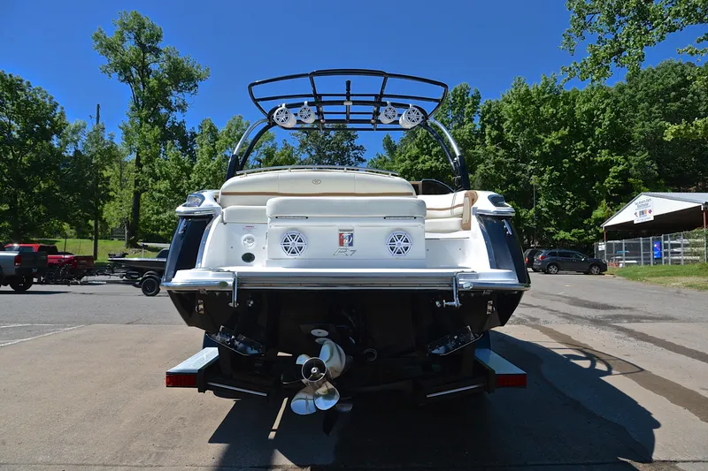 Slide: The Image of 2018 Cobalt R7 boat rear view, parked outdoors with trees and clear sky. - 14