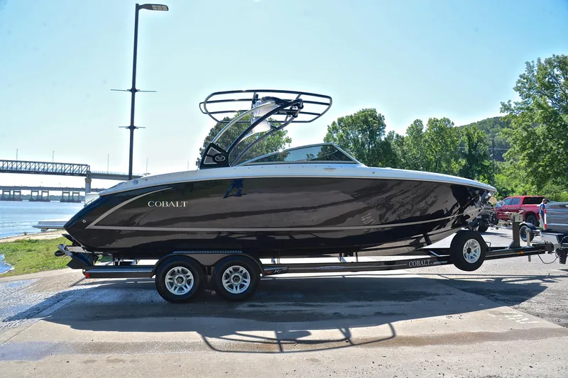 Slide: The Image of 2018 Cobalt R7 boat on trailer by riverside, under clear sky. - 16