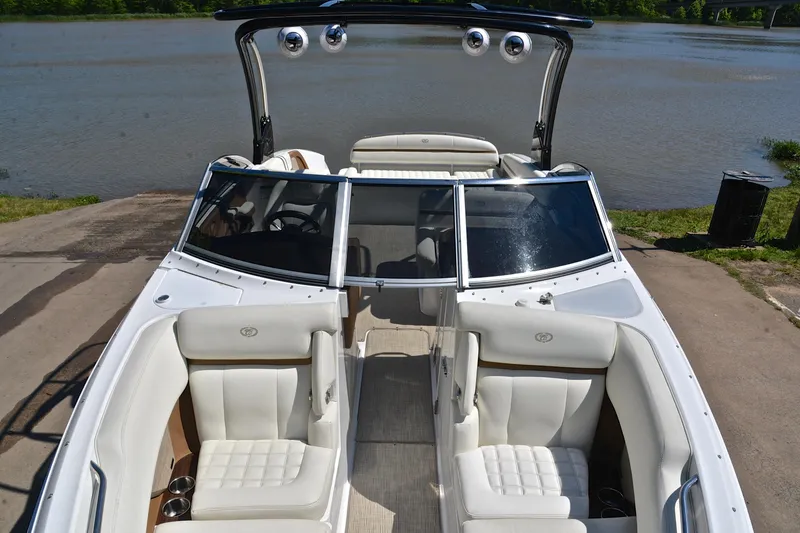 Slide: The Image of 2018 Cobalt R7 boat with white interior, docked by a serene lake. - 21