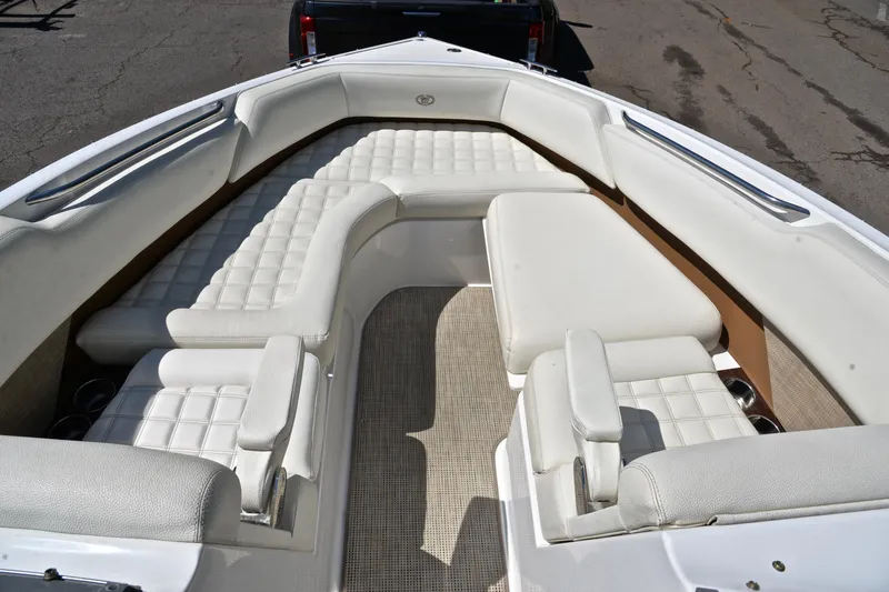 Slide: The Image of 2018 Cobalt R7 boat interior with white cushioned seating and sleek design. - 22