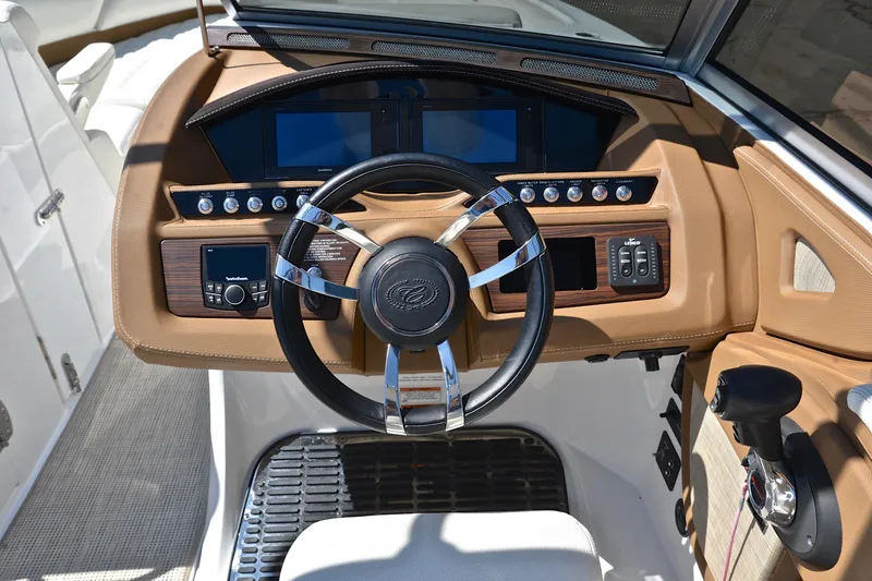 Slide: The Image of 2018 Cobalt R7 boat dashboard with steering wheel and control panel. - 27