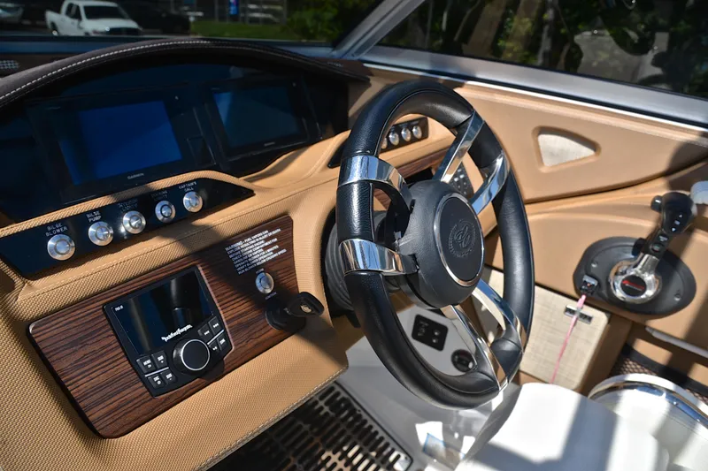 Slide: The Image of Interior of a 2018 Cobalt R7 boat featuring a sleek steering wheel and control panel. - 28