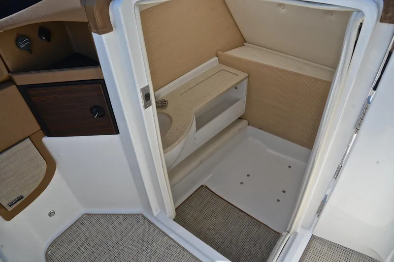 Slide: The Image of 2018 Cobalt R7 boat interior with compact bathroom and sink area. - 29