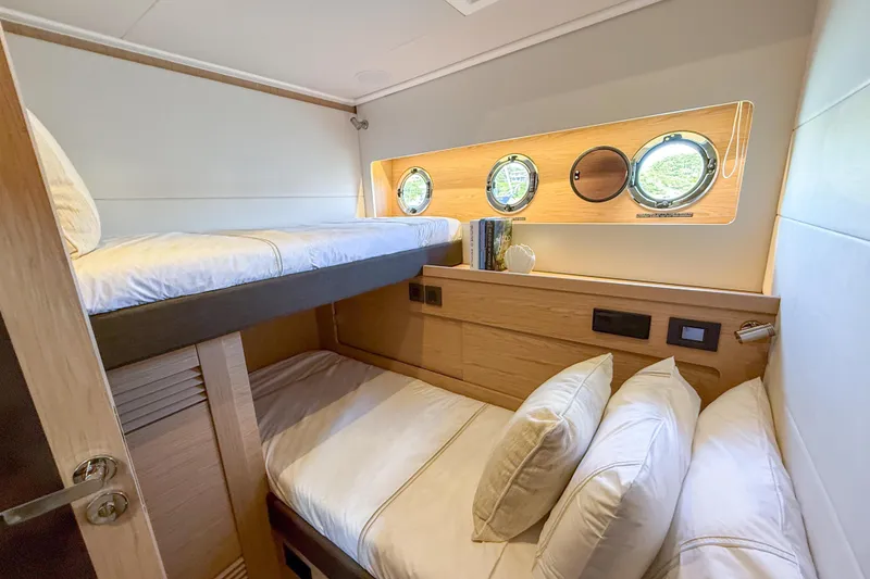 Slide: The Image of Cozy cabin with bunk beds in 2026 Beneteau Swift Trawler 54 yacht. - 14