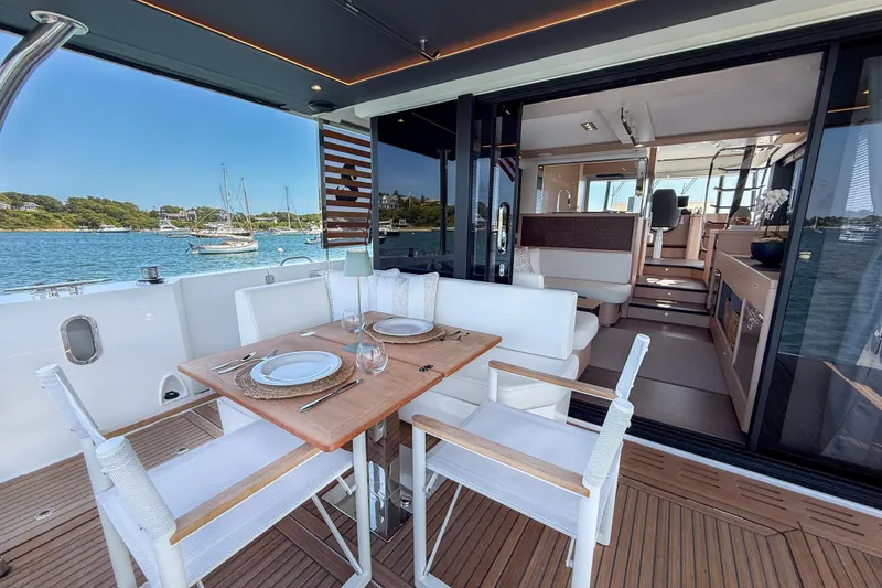 Slide: The Image of Luxurious 2026 Beneteau Swift Trawler 54 yacht with elegant dining area and scenic ocean view. - 16