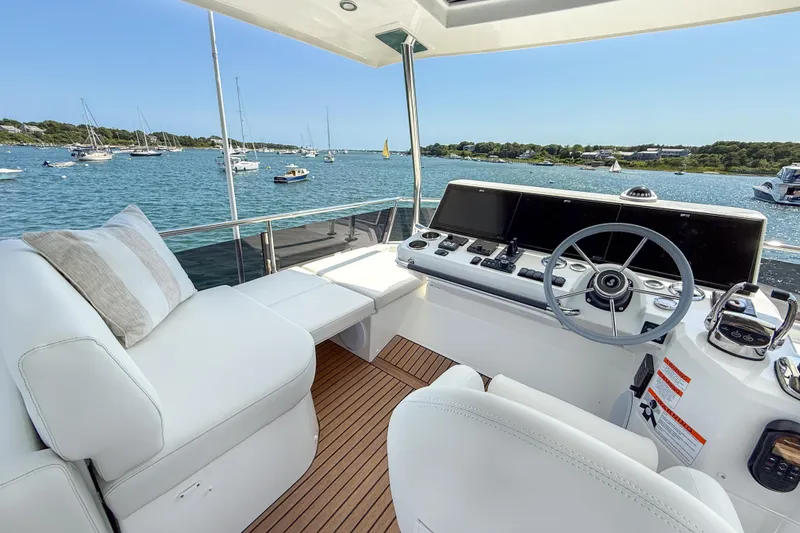 Slide: The Image of Helm of 2026 Beneteau Swift Trawler 54 with scenic ocean view. - 17