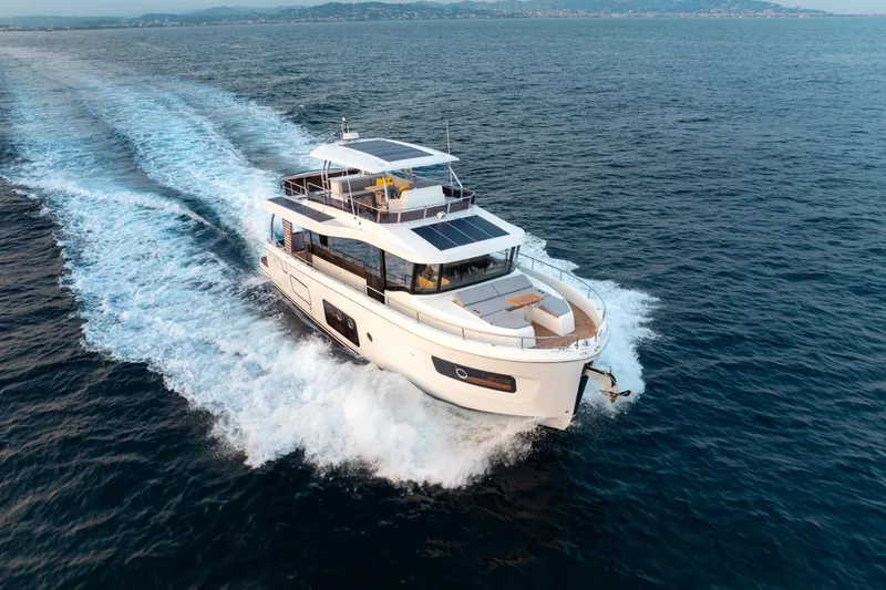 Slide: The Image of 2026 Beneteau Swift Trawler 54 cruising on open sea, showcasing sleek design and performance. - 29