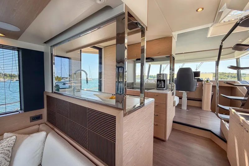 Slide: The Image of Luxurious interior of 2026 Beneteau Swift Trawler 54 with modern kitchen and helm station. - 6