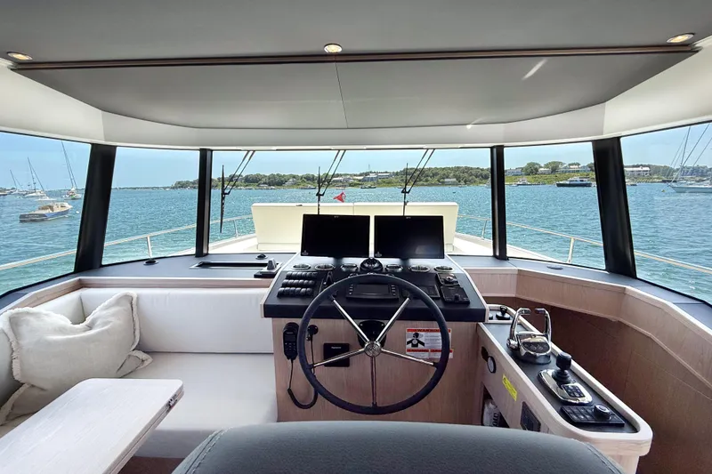 Slide: The Image of Interior helm of 2026 Beneteau Swift Trawler 54 with panoramic sea view. - 8
