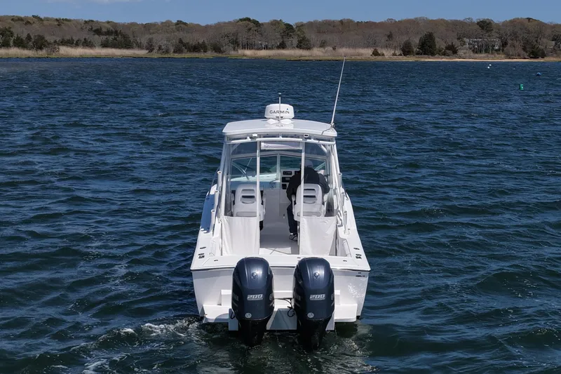 Slide: The Image of 2018 Albemarle 25 Express boat with dual engines on open water. - 10