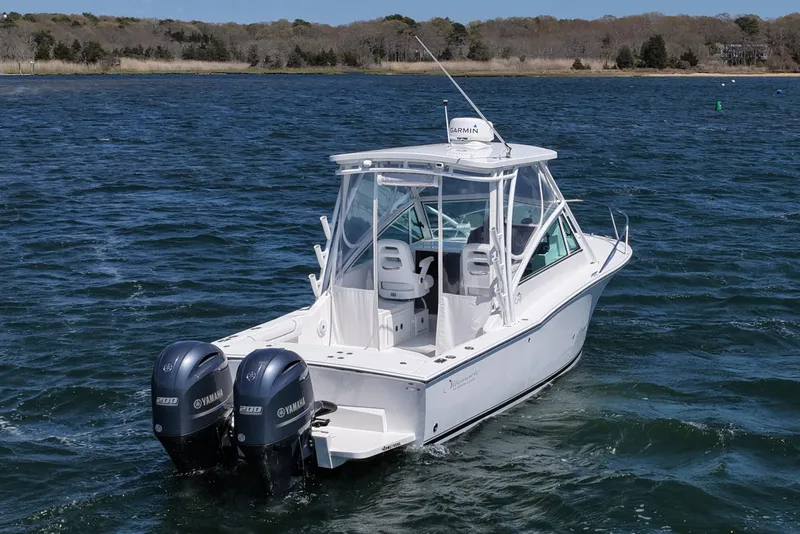 Slide: The Image of 2018 Albemarle 25 Express boat with twin Yamaha engines on open water. - 11