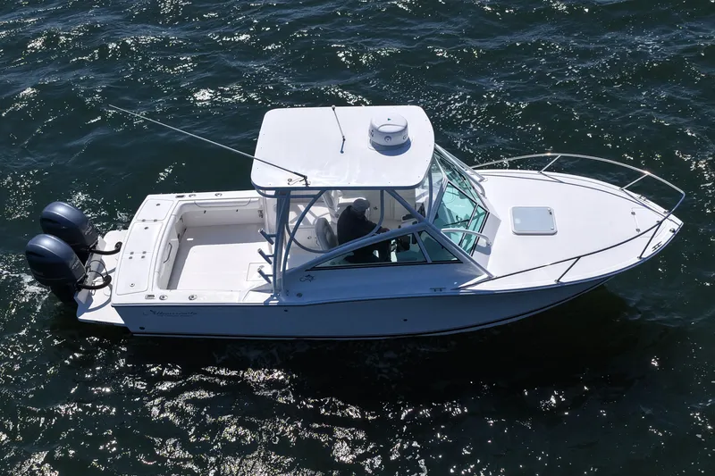 Slide: The Image of 2018 Albemarle 25 Express boat cruising on open water, featuring dual outboard engines. - 17