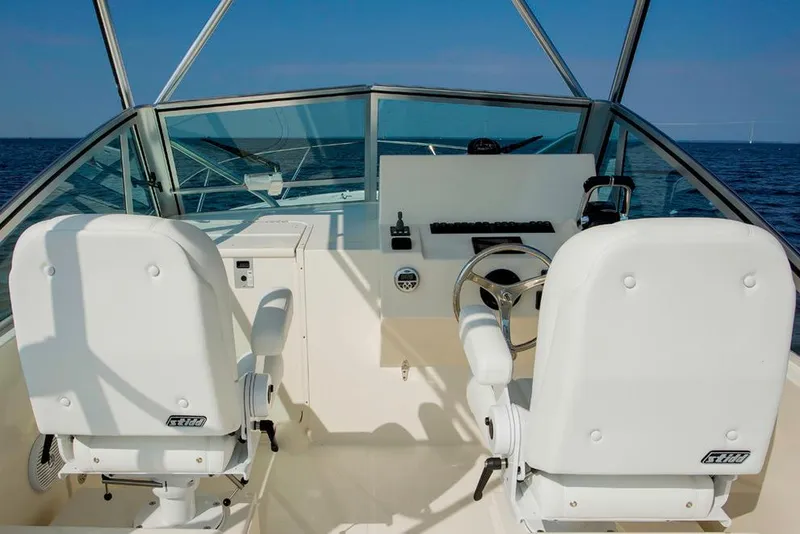 Slide: The Image of Manufacturer Provided Image: 2018 Albemarle 25 Express boat cockpit with dual white seats and steering wheel. - 19