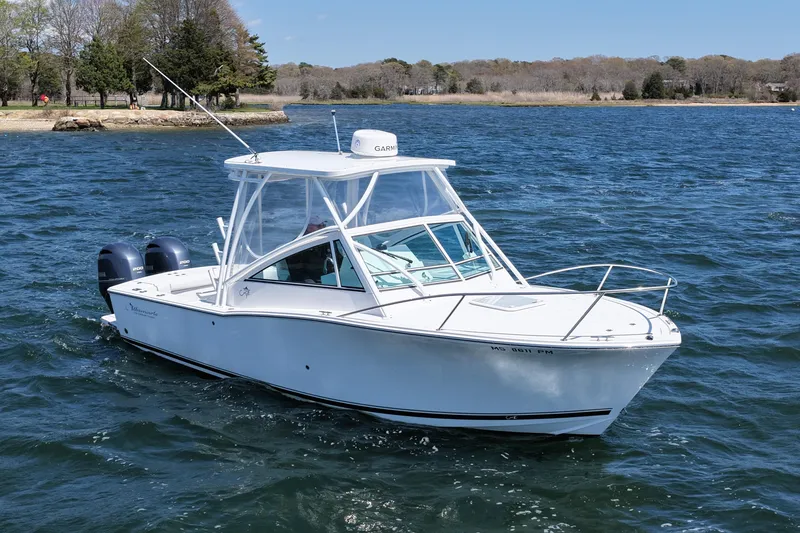 Slide: The Image of 2018 Albemarle 25 Express boat cruising on a scenic lake. - 2