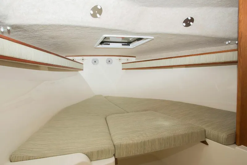 Slide: The Image of Manufacturer Provided Image: 2018 Albemarle 25 Express cabin interior with cushioned seating and overhead hatch. - 24