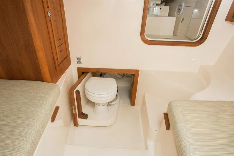 Slide: The Image of Manufacturer Provided Image: 2018 Albemarle 25 Express cabin interior with toilet and seating. - 25