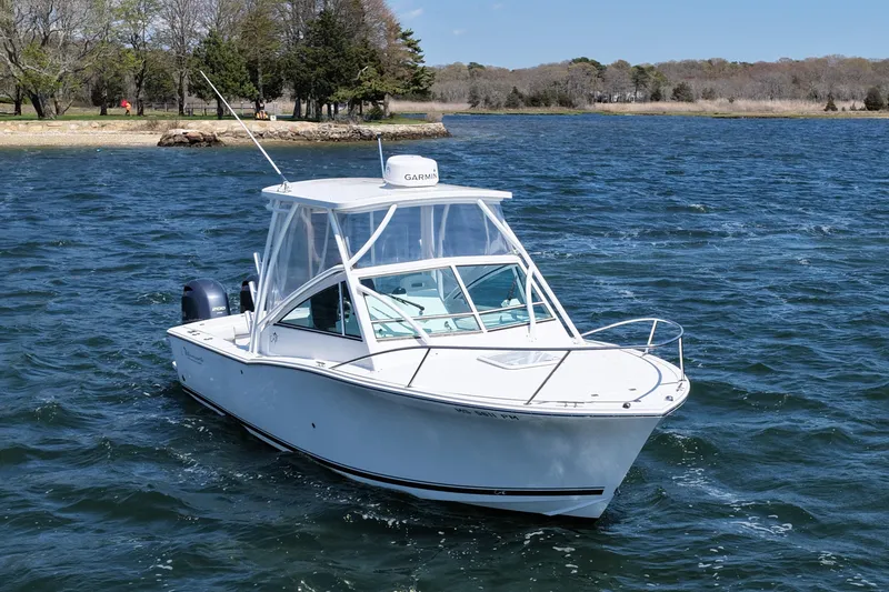 Slide: The Image of 2018 Albemarle 25 Express boat cruising on a scenic lake. - 3