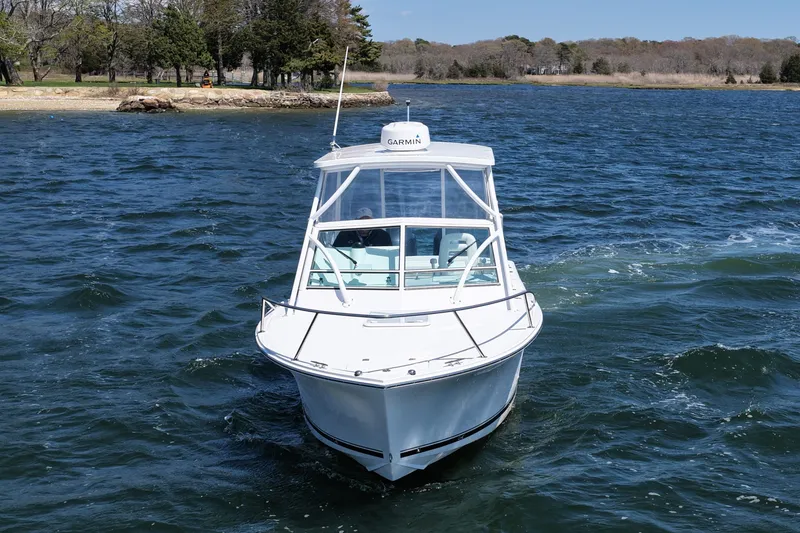 Slide: The Image of 2018 Albemarle 25 Express boat cruising on a scenic lake. - 4