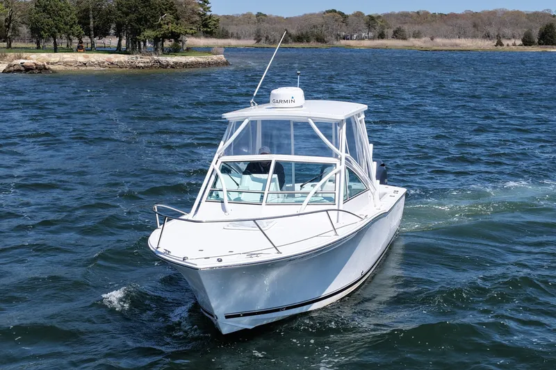 Slide: The Image of 2018 Albemarle 25 Express boat cruising on a scenic lake. - 5