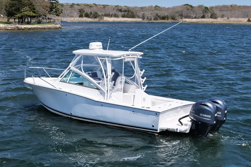 Slide: The Image of 2018 Albemarle 25 Express boat with twin Yamaha engines on a scenic waterway. - 8