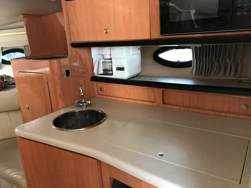 Slide: The Image of 1999 Regal 322 Commodore yacht interior kitchen with sink and coffee maker. - 5
