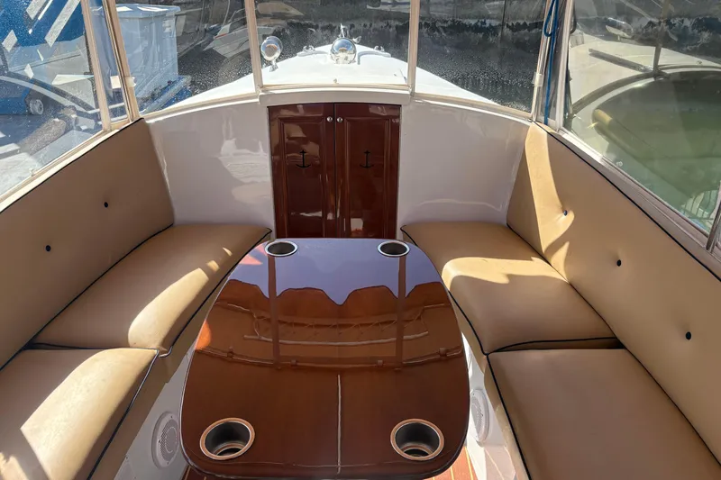 Slide: The Image of Interior of 2019 Duffy Cuddy Cabin 22 with cushioned seating and polished table. - 10