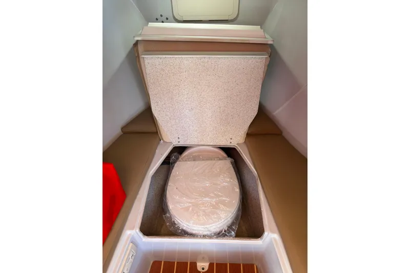 Slide: The Image of Interior of 2019 Duffy Cuddy Cabin 22 showing compact marine toilet setup. - 12
