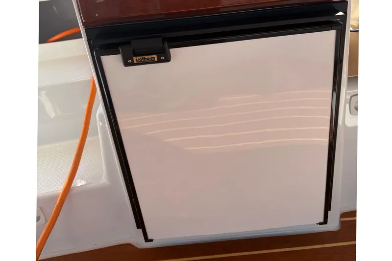 Slide: The Image of Refrigerator on 2019 Duffy Cuddy Cabin 22 boat with orange power cable. - 13