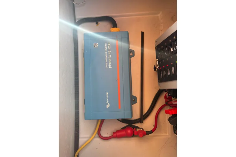 Slide: The Image of Electrical system inside a 2019 Duffy Cuddy Cabin 22 boat, featuring a Phoenix inverter. - 14