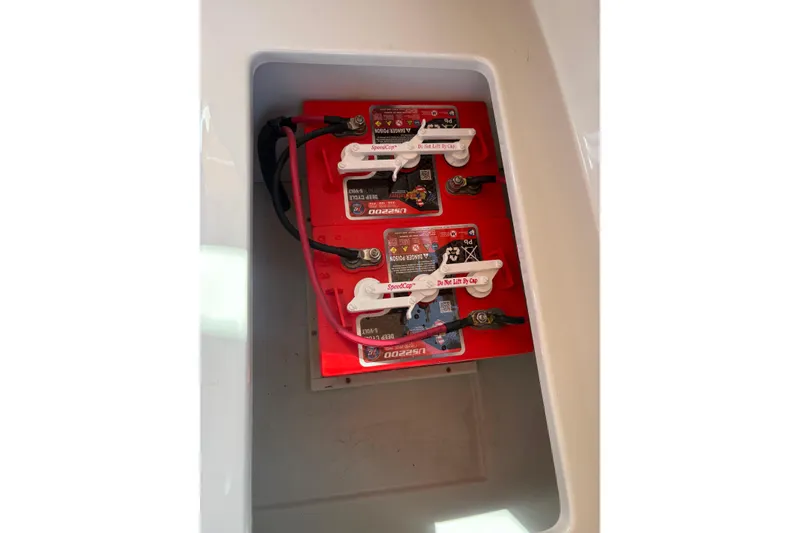 Slide: The Image of Battery compartment of a 2019 Duffy Cuddy Cabin 22 boat, featuring red batteries. - 16
