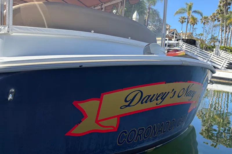 Slide: The Image of 2019 Duffy Cuddy Cabin 22 boat docked, featuring "Davey's Navy" text. - 5