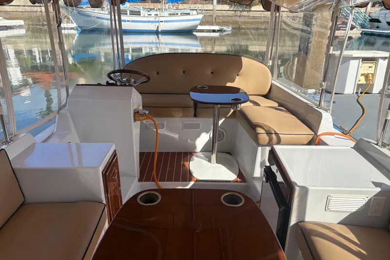 Slide: The Image of Interior of a 2019 Duffy Cuddy Cabin 22 boat with seating and table. - 7