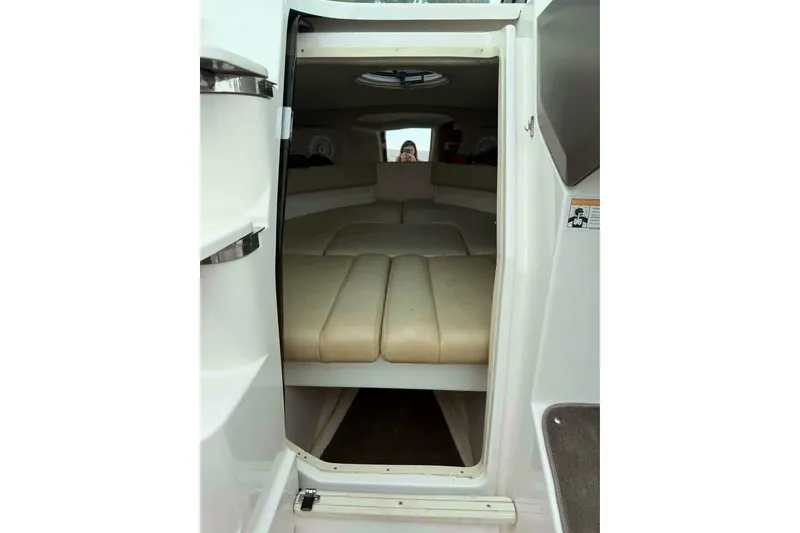 Slide: The Image of Interior view of a 2008 Regal 2250 Cuddy cabin with beige seating. - 10
