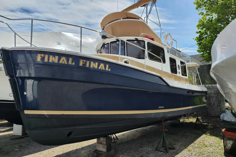 The Image of 2019 Ranger Tugs R-31 CB boat named "Final Final" on dry dock, blue and tan exterior. - 0