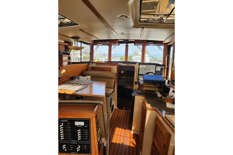 Slide: The Image of Interior of 2019 Ranger Tugs R-31 CB boat, featuring wood finishes and navigation equipment. - 10