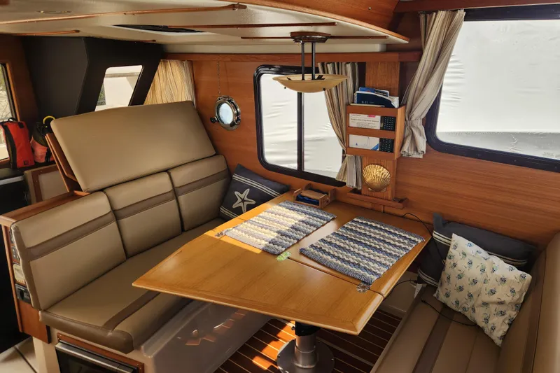 Slide: The Image of Interior of 2019 Ranger Tugs R-31 CB with cozy seating and nautical decor. - 14