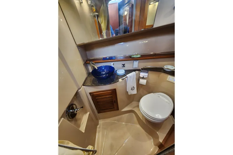 Slide: The Image of 2019 Ranger Tugs R-31 CB bathroom with blue sink, toilet, and mirror. - 21