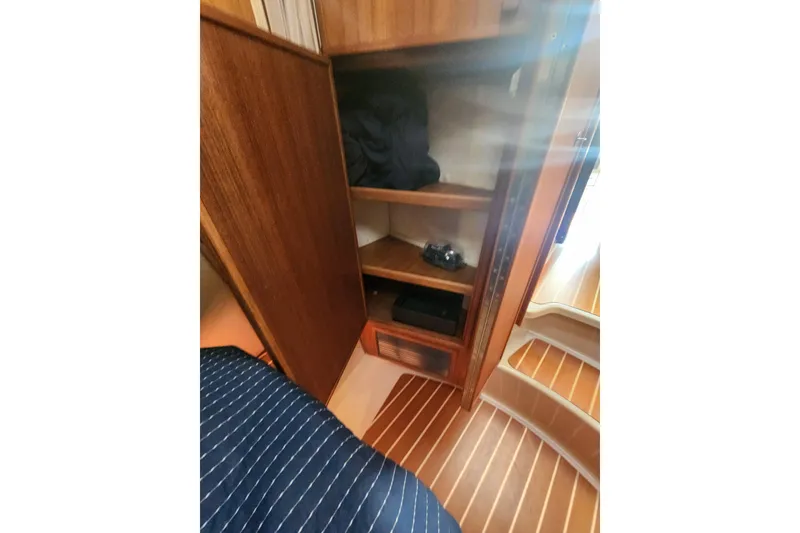 Slide: The Image of 2019 Ranger Tugs R-31 CB interior with wooden cabinetry and striped flooring. - 23