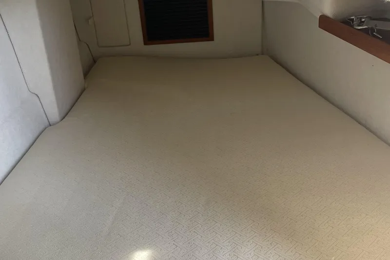 Slide: The Image of 2019 Ranger Tugs R-31 CB interior cabin with beige upholstery and wooden accents. - 25