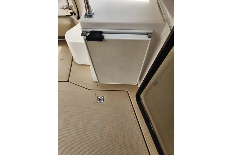 Slide: The Image of 2019 Ranger Tugs R-31 CB interior showing beige flooring and storage compartment. - 30