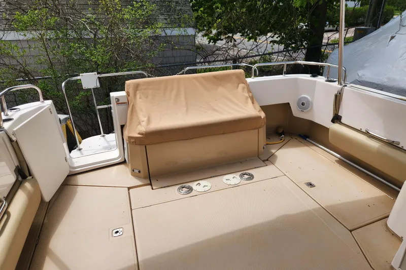 Slide: The Image of 2019 Ranger Tugs R-31 CB boat deck with beige seating and railing. - 32