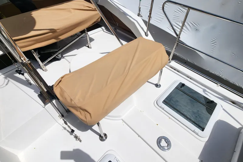 Slide: The Image of 2019 Ranger Tugs R-31 CB deck with tan-covered seating and stainless steel railings. - 33