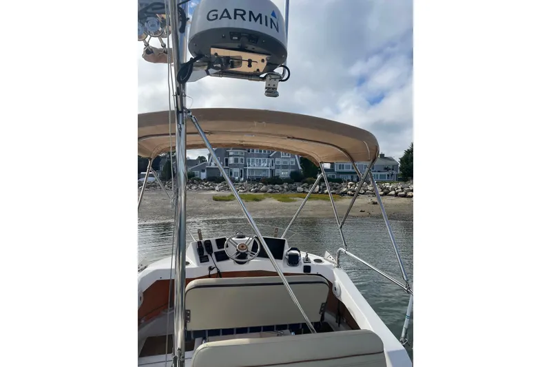 Slide: The Image of 2019 Ranger Tugs R-31 CB boat with Garmin radar, docked near waterfront homes. - 34
